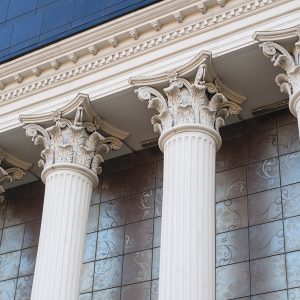 Architectural white Capital columns on the facade of the building.